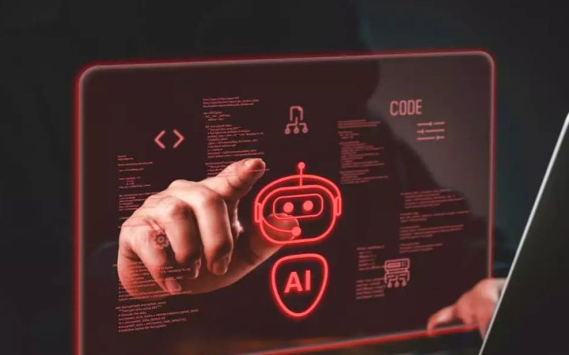 En person pekar på en digital röd hologramdisplay med AI-symboler och kod framför en laptop.